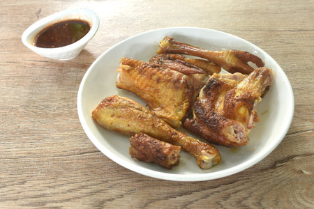 roasted chop chicken meat wing and leg on plate dipping with sweet and spicy sauceの写真素材