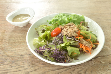 chop tuna with vegetable salad on plate dressing sesame oil japanese cream sauceの写真素材