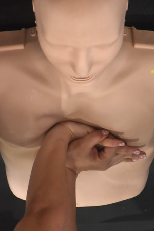 woman hand training CPR or cardiopulmonary resuscitation to helping life from heart diseaseの写真素材