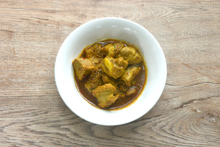 spicy fried pork bone with yellow curry and basil leaf Thai southern food on bowl
