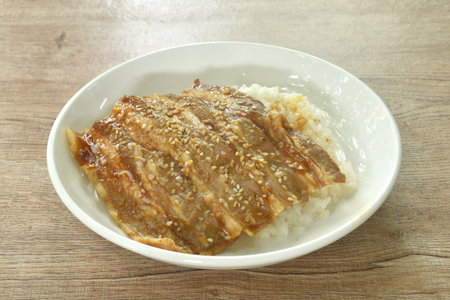 slice grilled salt fat pork with teriyaki sauce dressing white sesame topping Japanese rice on plateの写真素材