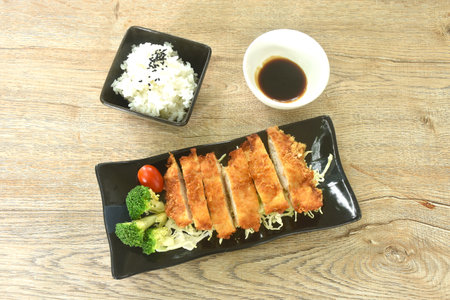 fried chicken with bred flour topping vegetable with rice dressing black sesame dipping sweet black sauceの写真素材