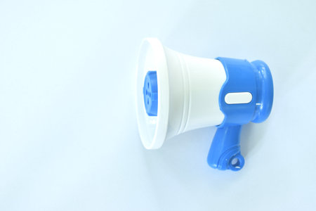toy plastic white and blue megaphone arranging on white backgroundの写真素材