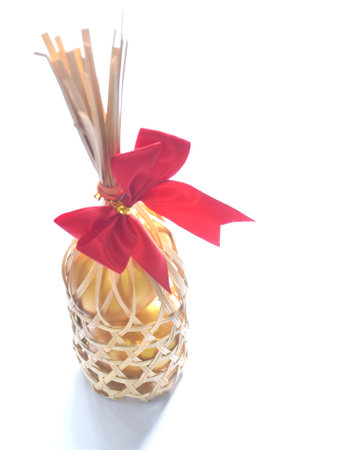 golden egg in wooden basket on white backgroundの写真素材