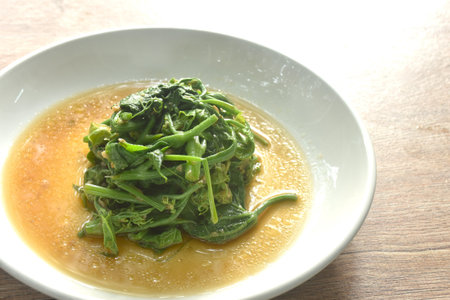 fried Chayote sprout with chili and soybean sauce on plateの写真素材