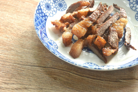 fried crispy salty beef meat with pepper on plateの写真素材