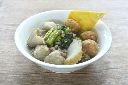 boiled fish ball with dumpling topping shrimp ball and morning glory in clear soup on bowlの写真素材