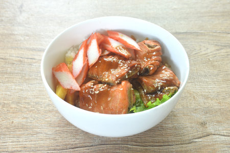 grilled saba fish or mackerel topping crab stick and lettuce on japanese rice in bowlの写真素材