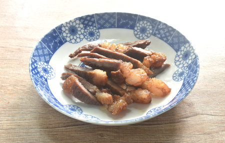 fried crispy salty beef meat with pepper on plateの写真素材