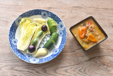 herb soya bean sauce with mashed pork dipping fresh vegetable on plateの写真素材