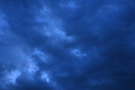dark rain cloud floating on sky at sunset in evening
