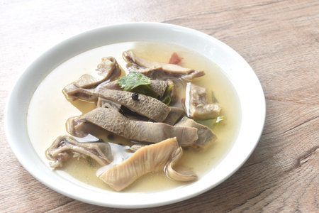 boiled braised slice pork stomuach with black pepper in clear bone soup on plateの写真素材