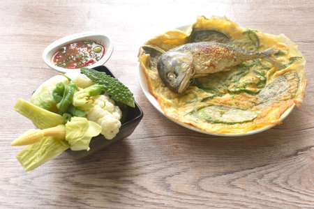 batter fried egg stuffed eggplant and mackerel with boiled vegetable on plate dipping spicy shrimp paste sauceの写真素材