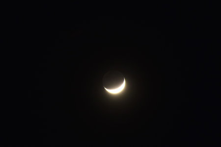half moon shining floating on sky in nightの写真素材