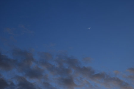 half moon floating on blue sky in twilight backgroundの写真素材