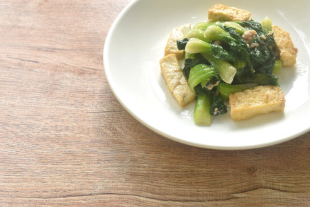 stir fried Chinese cabbage with slice tofu and chop pork in soy sauce on plateの写真素材