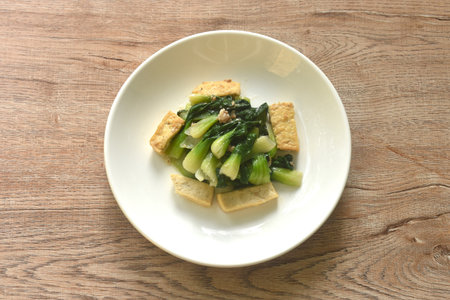 stir fried Chinese cabbage with slice tofu and chop pork in soy sauce on plateの写真素材