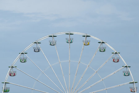 big ferris wheel in theme park machine for fun of family on sunny dayの写真素材
