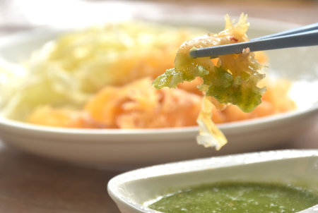 boiled jellyfish with slice cabbage on plate dipping Thai spicy and sour seafood sauceの写真素材