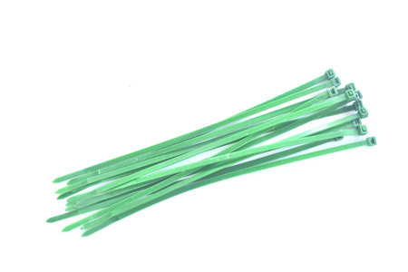 green plastic twist belt for roll oblect arranging on white backgroundの写真素材