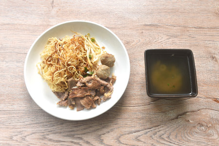 dry boiled Chinese yellow egg noodles with braised beef and meatball dressing black sweet soy sauce...