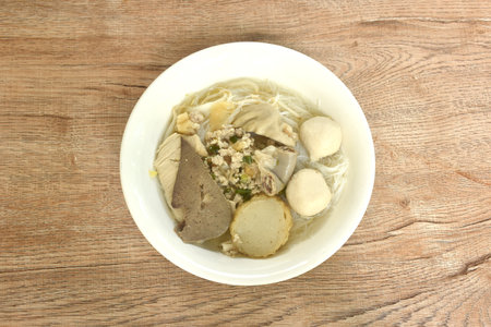 boiled vermicelli thin rice noodles topping pork ball with chop pork in clear soup on bowl
