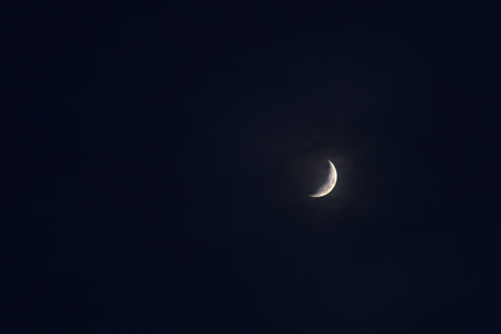half moon covering by cloud floating on sky in night background