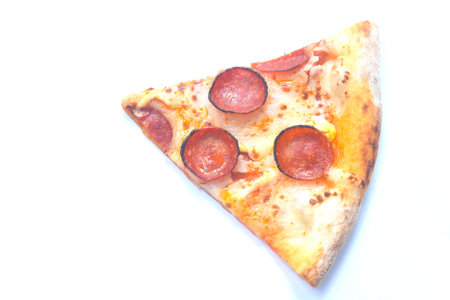 piece of homemade peperoni pizza topping slice salami on white backgroundの写真素材