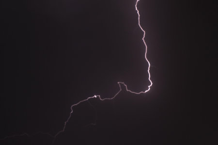 blurry lightning on cloud in dark sky at night white rain storm comingの写真素材