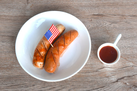 grilled smoked American pork sausage arranging on plate dipping ketchup sauceの写真素材