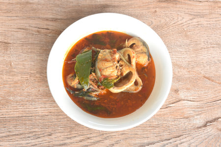 spicy chili boiled catfish with eggplant and basil in curry soup on bowlの写真素材