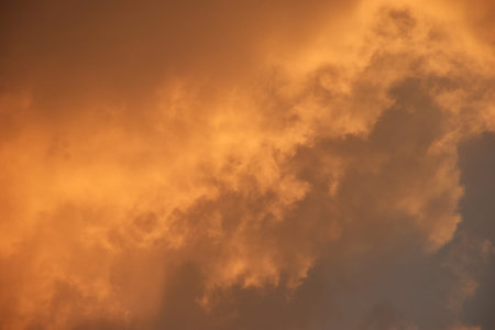white and orange cloud spreading on twilight sunset blue sky in evening