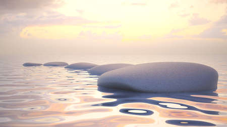 Zen stones in water by the sunset.の写真素材
