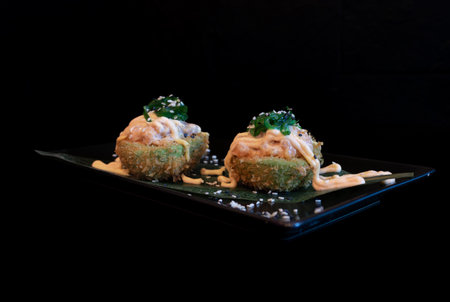 japanese cuisine. tempura sushi on the black background.