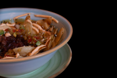 Close-up of a bowl of vegetable salad on a black background