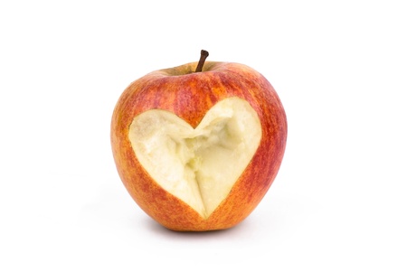  Red apple with a bite with a shape of a heartの写真素材