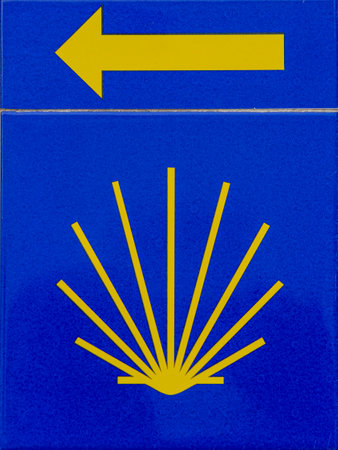 blue direction symbol with arrow to the left side of the Camino de Santiago trailの写真素材