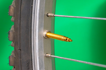 Presta valve without bicycle tire cap on green background.の写真素材