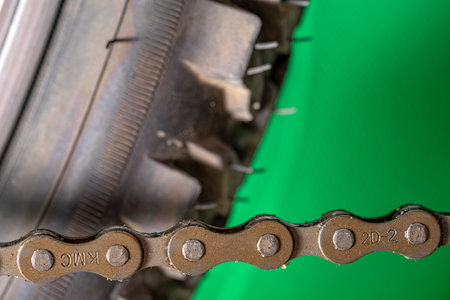 Bike chain on green background. Close-up of bicycle chain.