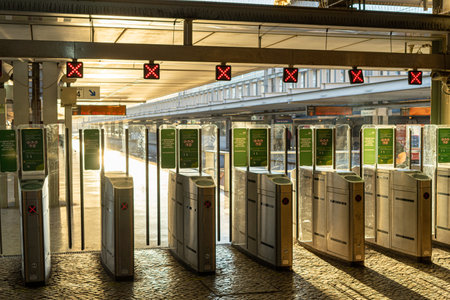 gates, or turnstiles for accessing the train at the railway station with red signs.
