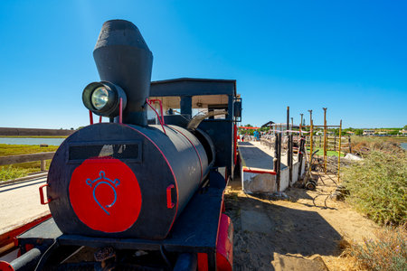 Old steam locomotive on the background of a blue sky with clouds