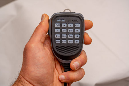 A man's hand holds a remote control.