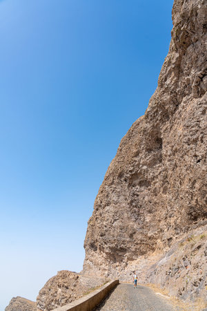 Woman walking on the road to the top of the mountain. Crimea, Ukraineの写真素材