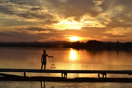 Child with basket of fishの写真素材