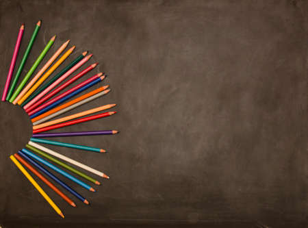 Board with colored crayons and a maskの写真素材