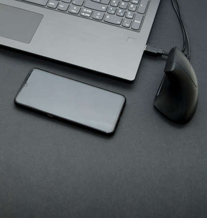 Laptop with smart phone, glasses and pen for workingの写真素材