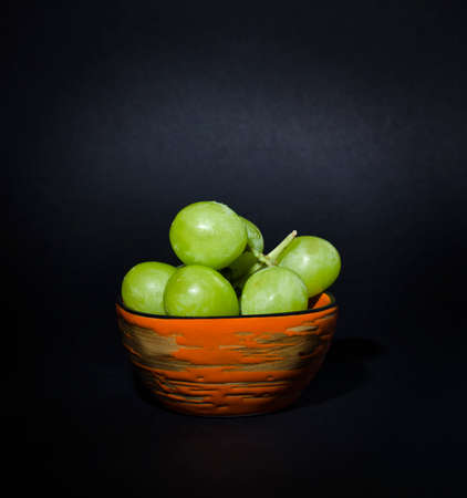 Grapes on a plate on the tableの写真素材