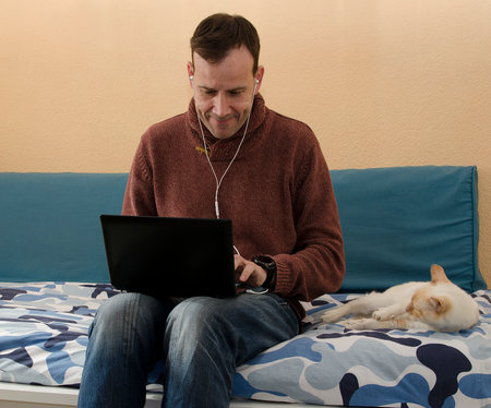 Businessman speaking on the phone and working with laptopの写真素材