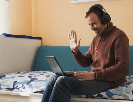 Businessman speaking on the phone and working with laptopの写真素材