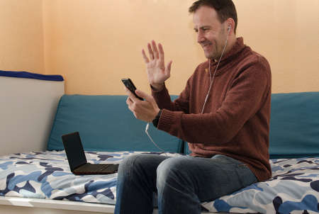 Businessman speaking on the phone and working with laptopの写真素材